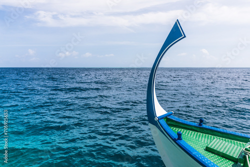 bow of a traditional Maldivian dhoni boat in the Indian Ocean lagoon in the Maldives