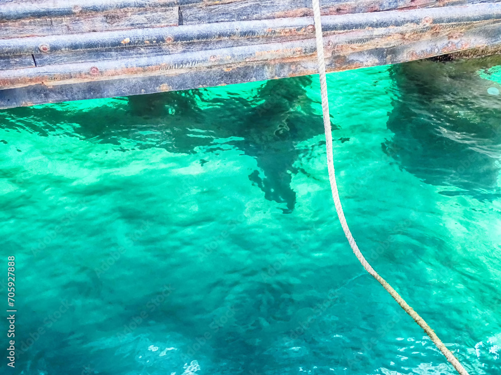 Boat moored in the port and turquoise waters of the sea