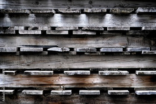 stacked logs on the side of a building with spotlights photo