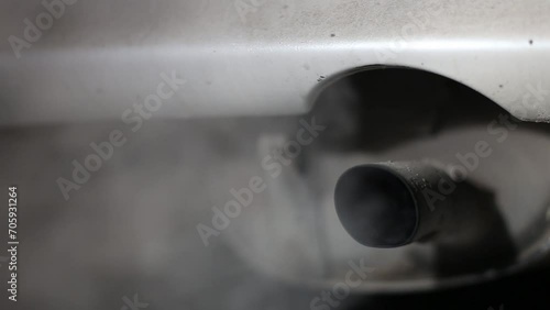 car exhaust pipe close-up with the engine running