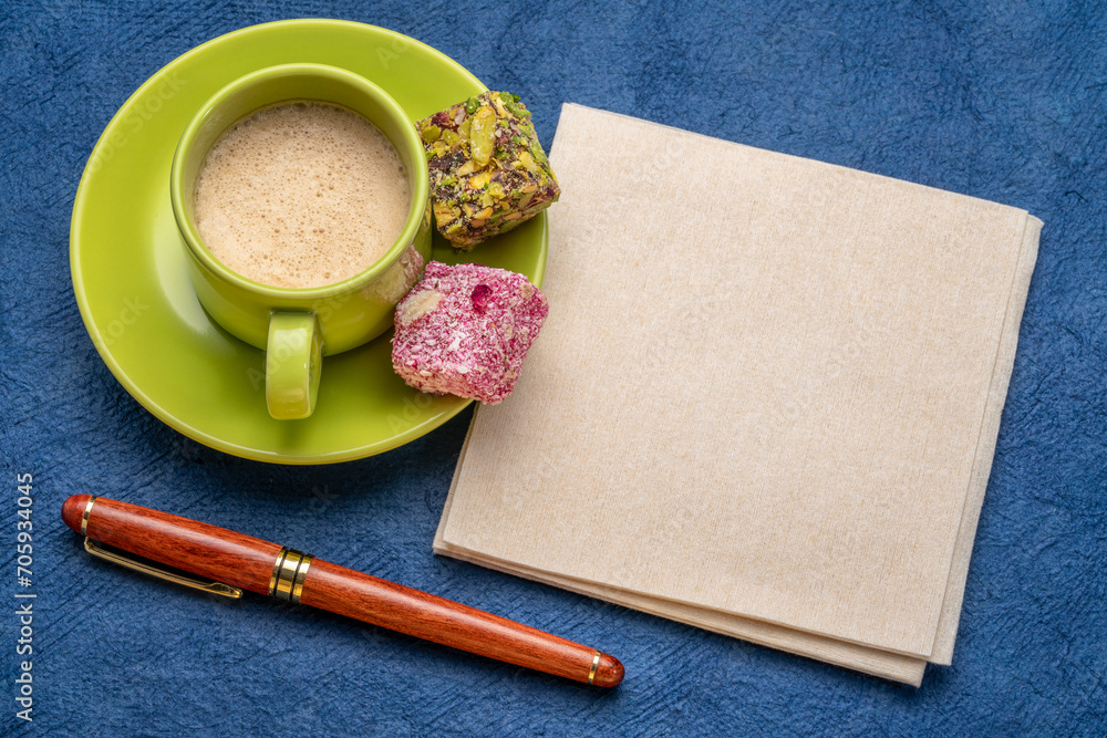 blank napkin with a pen, a cup of coffee and candy blank napkin with a pen, a cup of coffee and candy