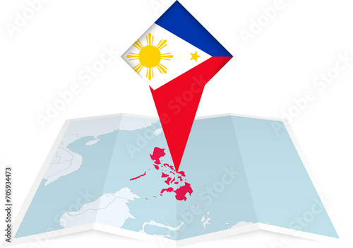 Philippines pin flag and map on a folded map photo