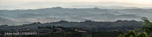 Typical Tuscan landscape with hills and cypresses in the very early morning near Montaione photo