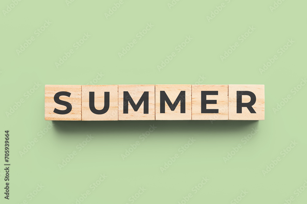 summer wooden cubes on green background summer wooden cubes on green background
