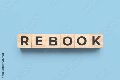 rebook wooden cubes on blue background