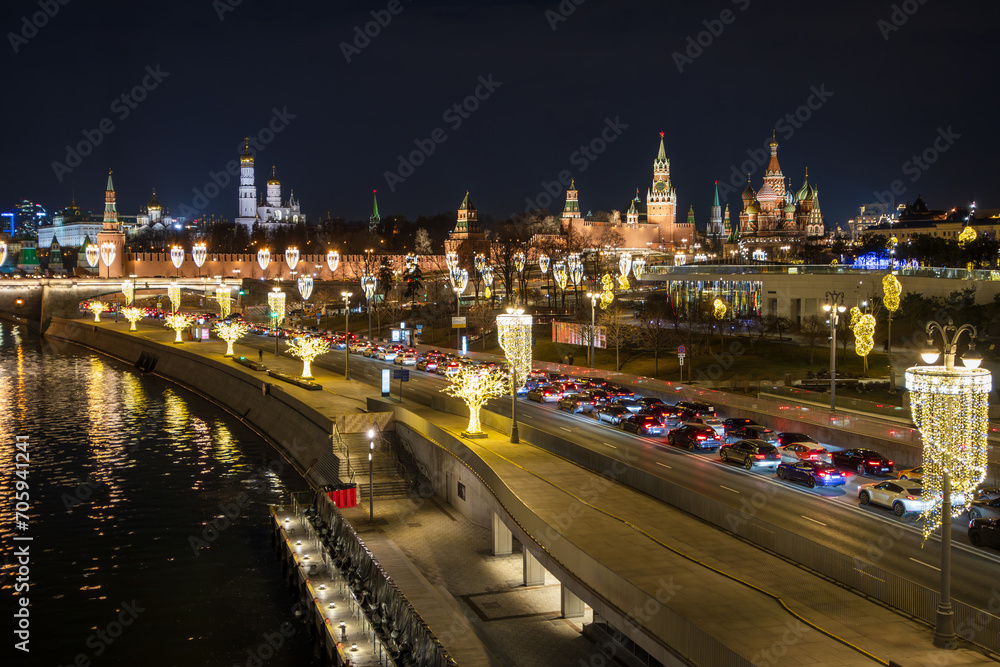 Moscow, Russia. Top view of Moskvoretskaya embankment. There is a traffic jam on the roadway. Many cars in a traffic jam. The Moscow Kremlin is in the distance. Beautiful street lighting.
