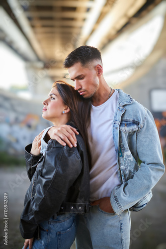 fashionable and youthful couple exudes style and love while striking poses on the city streets. © Ryzhkov Oleksandr