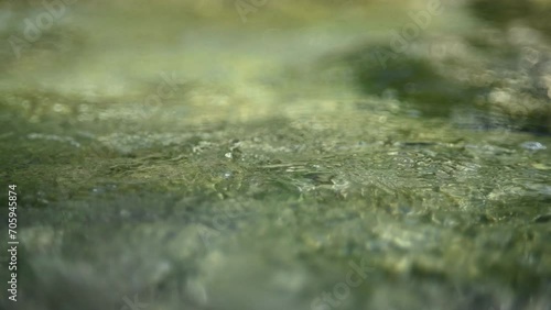 Flowing water from a mountain stream in the evening (abstract, slow motion) photo