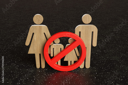 Wooden board cutout of a family having a red forbidden sign on children. Illustration of the concept of child-free restaurants and childless millennial couples photo