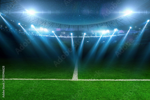 Modern football stadium with green lawn and blue spotlight. Soccer background. Football champions photo