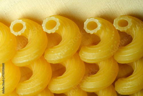 Grocery yellow background large raw rolled egg pasta