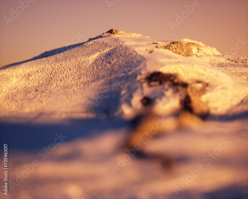 Snowy mountain during sunset.