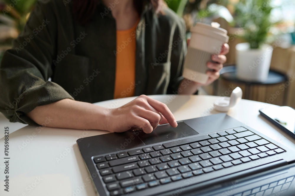 Fototapeta premium Hands of unrecognizable girl doing e-commerce on her laptop