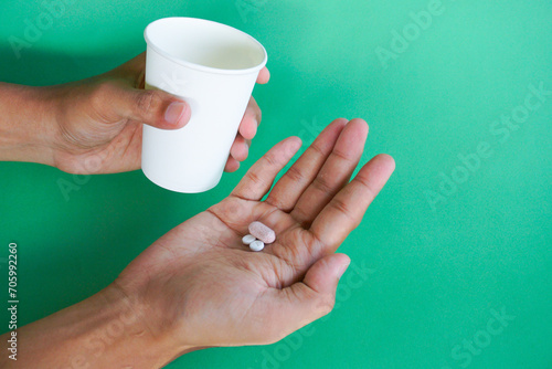 Billede på lærred Sick, asian young man, boy hand holding pill capsule, painkiller medicine from s