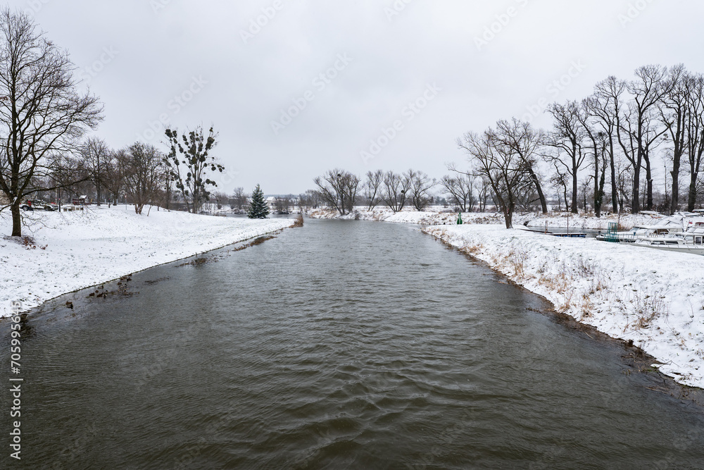 Zimowa panorama rzeki Osobłogi w popołudniowych godzinach pochmurnego szarego dnia w Zachodniej Polsce - obrazy, fototapety, plakaty 