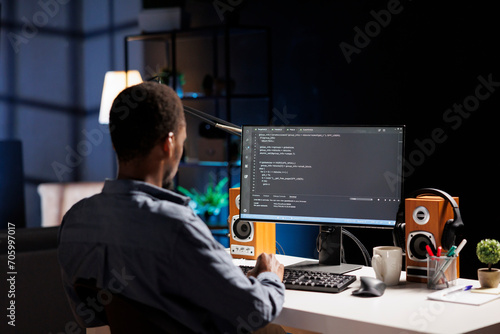 Male developer entering binary data on terminal panel while establishing html code. Software engineer works on troubleshooting with programming language, for protection of databases.