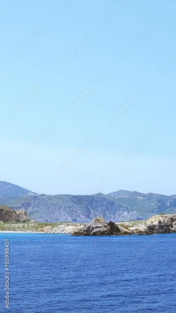 Panning view of coastline of Milos island, Greece, on clear sunny day Panning view of coastline of Milos island, Greece, on clear sunny day
