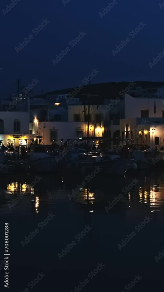Night view of harbor, restaurants and people in Naoussa, Paros, Greece Night view of harbor, restaurants and people in Naoussa, Paros, Greece
