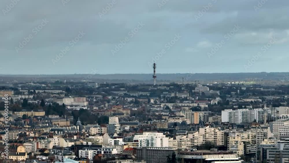 Urban spread of Rennes against a stormy backdrop.