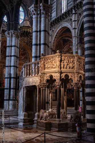 SIENA, ITALY - SEPTEMBER 23, 2023 - Rich ornate marble pulpit in the Siena cathedral, designed by Niccolo Pisano