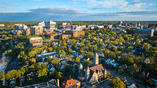 Aerial Golden Hour Over Historic Church and Urban Growth, Ann Arbor