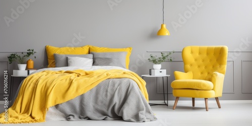 Bright bedroom with yellow vintage armchair, wardrobe, and grey and yellow bedding on bed with bedhead.