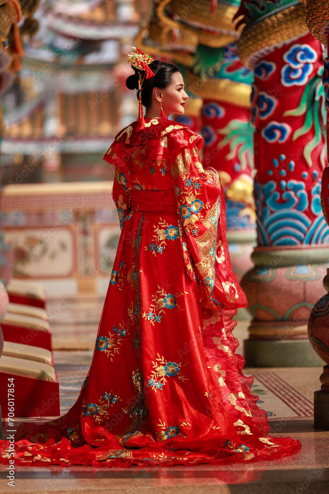 Chinese new year , Portrait of young asian woman with traditional red Chinese hong hao cheongsam in temple ,