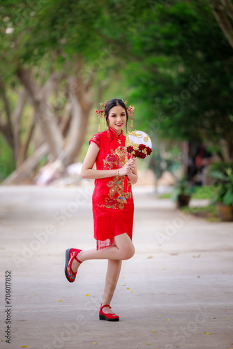 Chinese new year , Portrait of young asian woman with traditional Chinese  red drese in temple , photo