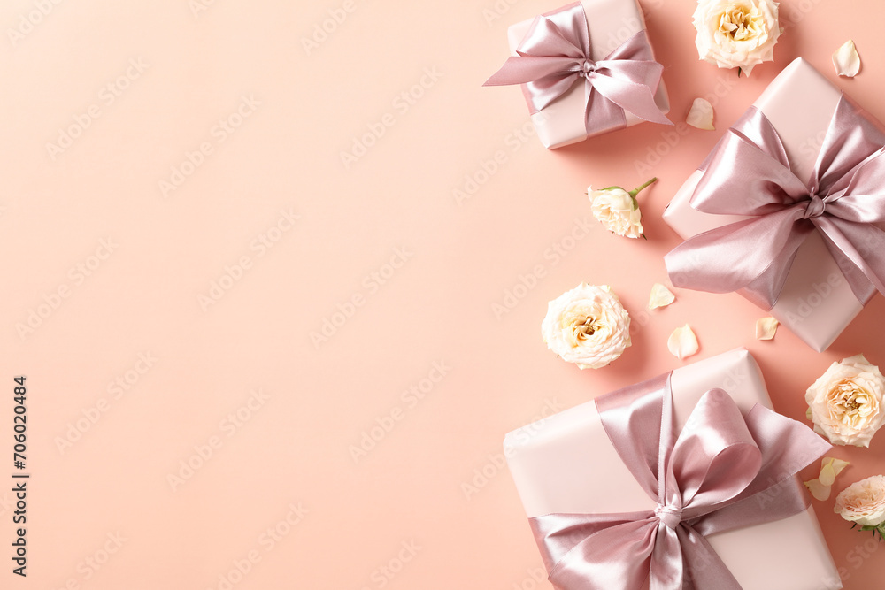 Happy Valentines day card. Flat lay gift boxes with pink ribbon bow, roses buds on peach table. Valentines Day background. Happy Valentines day card. Flat lay gift boxes with pink ribbon bow, roses buds on peach table. Valentines Day background.