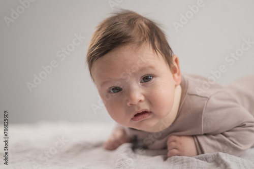 Portrait of a newborn baby lying on his stomach in an orthopedic collar. photo