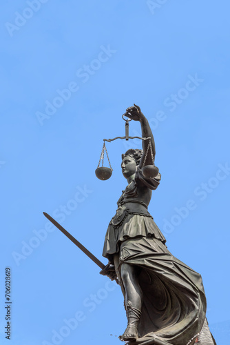lady justice with sword in Frankfurt under blue sky