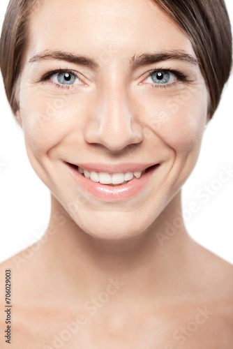 Beautiful girl with blue eyes close up beauty portrait. Smiling and looking at camera.