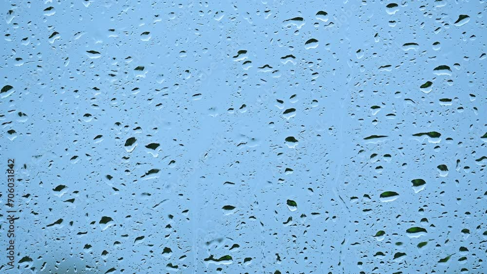 Close up raindrops sliding down window glass Close up raindrops sliding down window glass