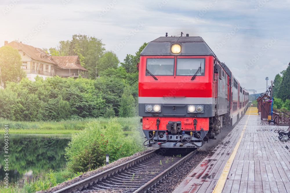 Naklejka premium Passenger train approaches to the platform.