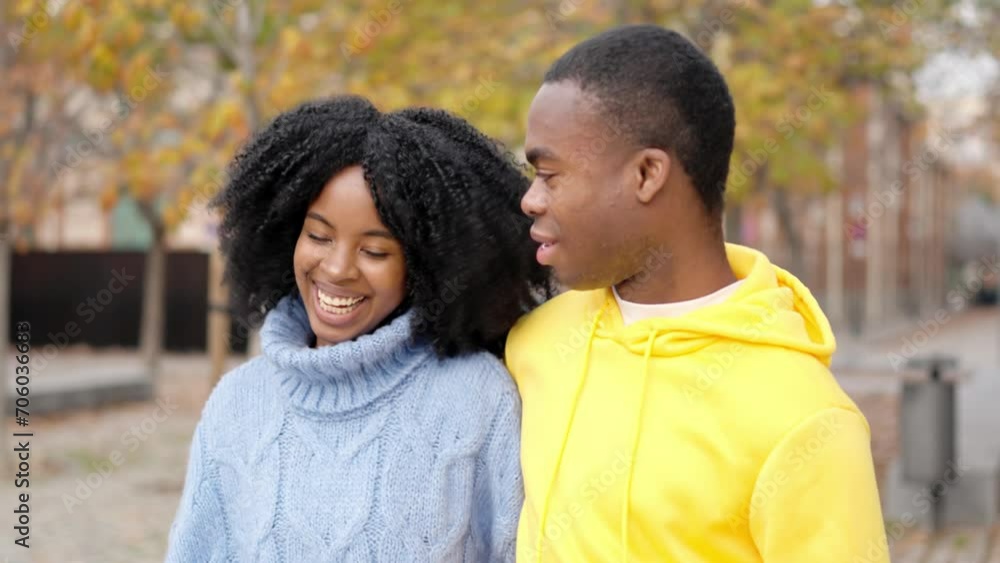African couple flirting while walking together along a street African couple flirting while walking together along a street