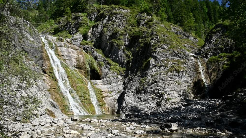 Two waterfalls in an alpine setting in the summer Two waterfalls in an alpine setting in the summer