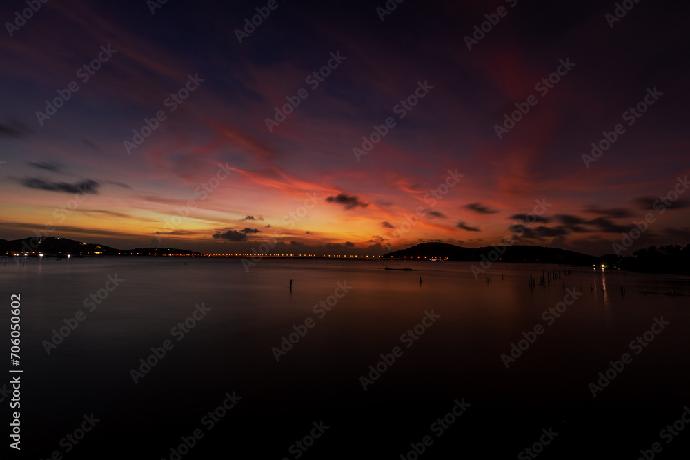 The background of the sea by the evening sea, with natural beauty (sea water, rocks, sky) and fishermen are fishing by the river bank, is a pleasure during travel.