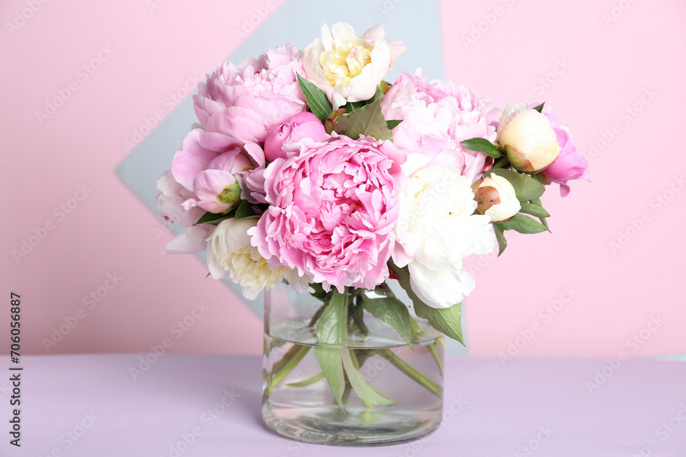 Bouquet of beautiful peonies in vase on lilac table Bouquet of beautiful peonies in vase on lilac table
