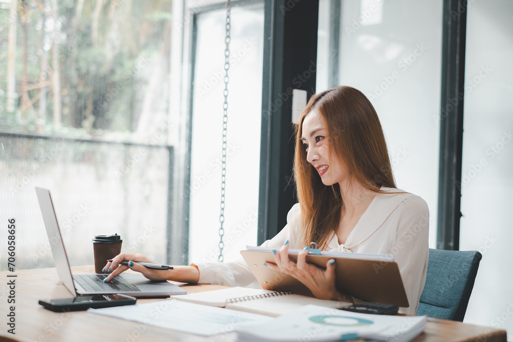 Business woman using business paper for doing math finance on office desk, tax, report, accounting, statistics, and analytical research concept Business woman using business paper for doing math finance on office desk, tax, report, accounting, statistics, and analytical research concept