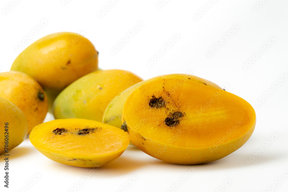 ripe juicy mangoes are infected by fruit beetles pest, isolated on white background