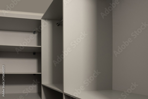 Stylish gray shelving from floor to ceiling. Many shelves. Furniture in a small dressing room