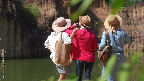 Group of Asian senior women friends hiking walking exercising together on holiday vacation, healthy elderly pensioner females happy traveling enjoy activities outdoors, society aging people lifestyle photo
