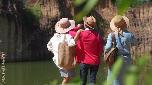 Group of Asian senior women friends hiking walking exercising together on holiday vacation, healthy elderly pensioner females happy traveling enjoy activities outdoors, society aging people lifestyle