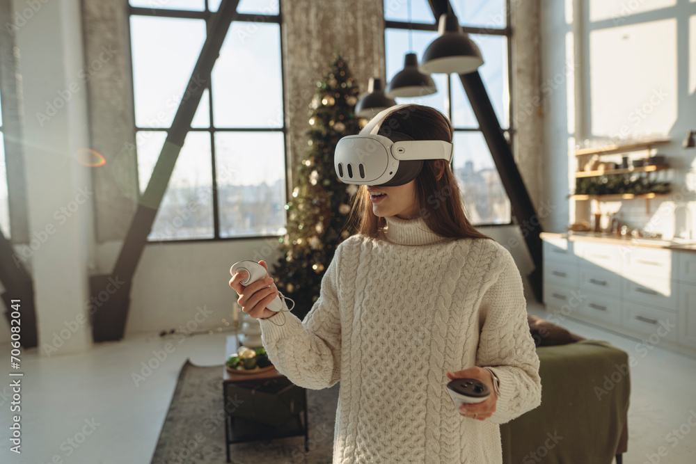 The beautiful girl in a virtual reality headset is expressing her experiences. The beautiful girl in a virtual reality headset is expressing her experiences.