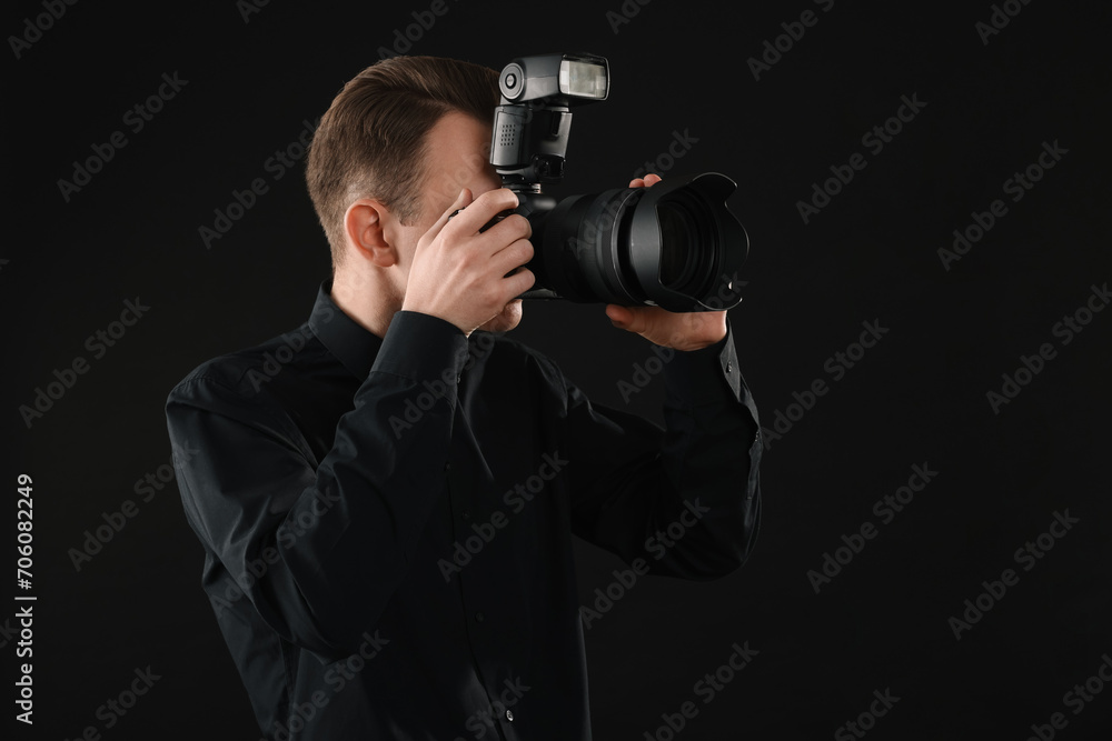 Professional photographer taking picture on black background Professional photographer taking picture on black background