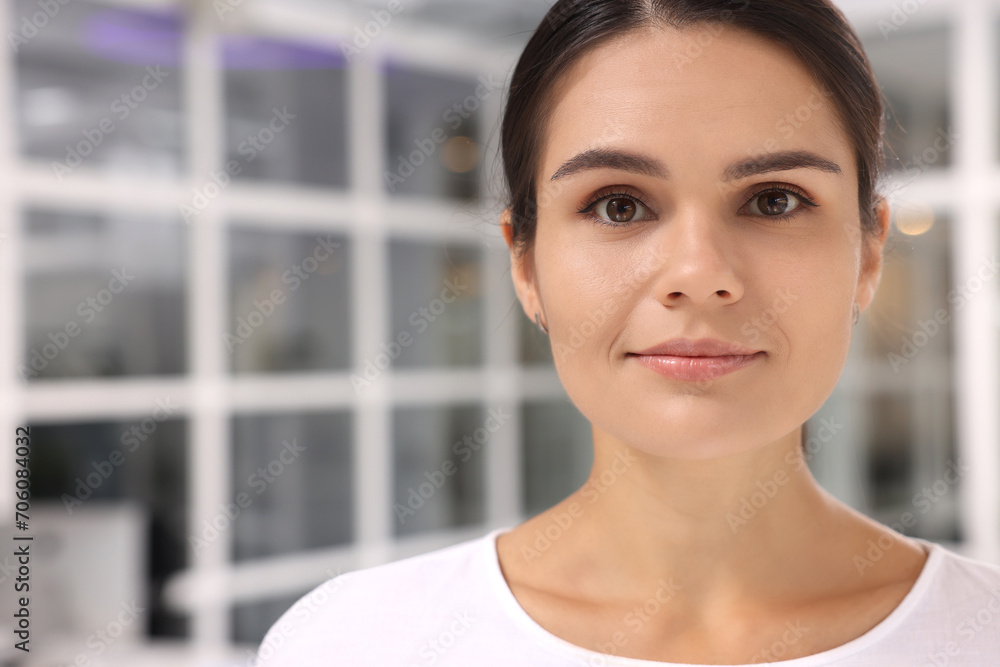 Portrait of beautiful young woman on blurred background, space for text Portrait of beautiful young woman on blurred background, space for text