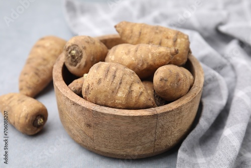 Photos Tubers of turnip rooted chervil on light grey table, closeup