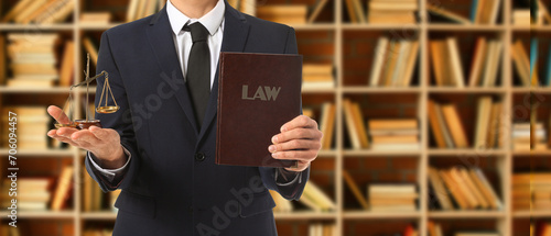 Male lawyer with book and scales of justice in office. Banner for design photo