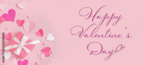 Greeting banner for Valentine's Day with beautiful paper hearts and gift on pink background