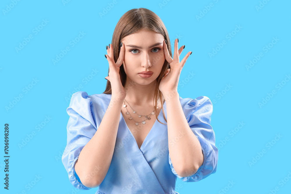 Fashionable young woman in stylish dress on light blue background Fashionable young woman in stylish dress on light blue background